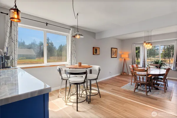 a dining room with furniture and wooden floor