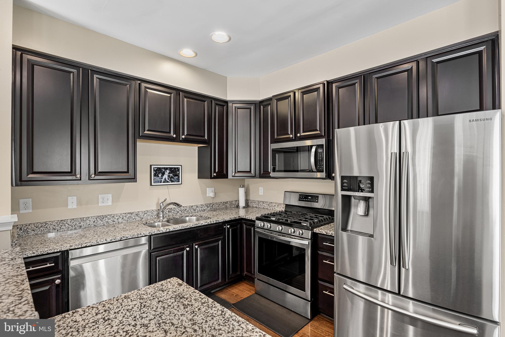 41 Franklin Circle Somerdale, NJ 08083 - Photo 8 of 26 a kitchen with granite countertop stainless steel appliances and wooden cabinets