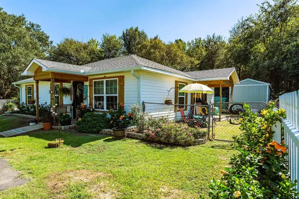 a view of a backyard with a table and chairs