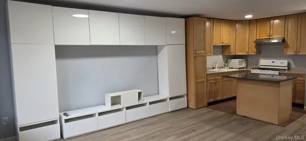 a kitchen with stainless steel appliances granite countertop a refrigerator a stove and a sink