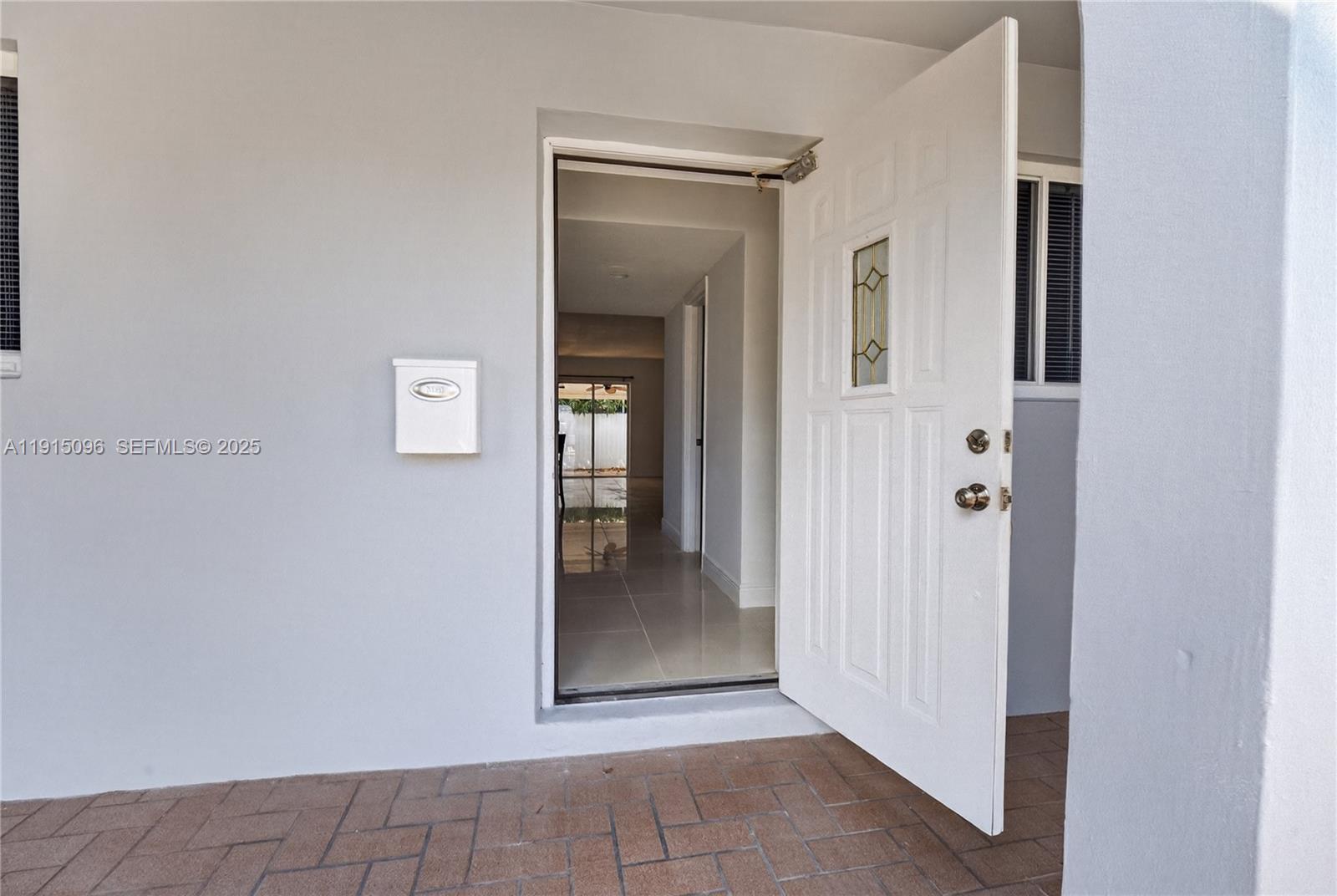 6822 West 2nd Lane Hialeah, FL 33014 - Photo 2 of 36 a view of a hallway with wooden floor and a livingroom view