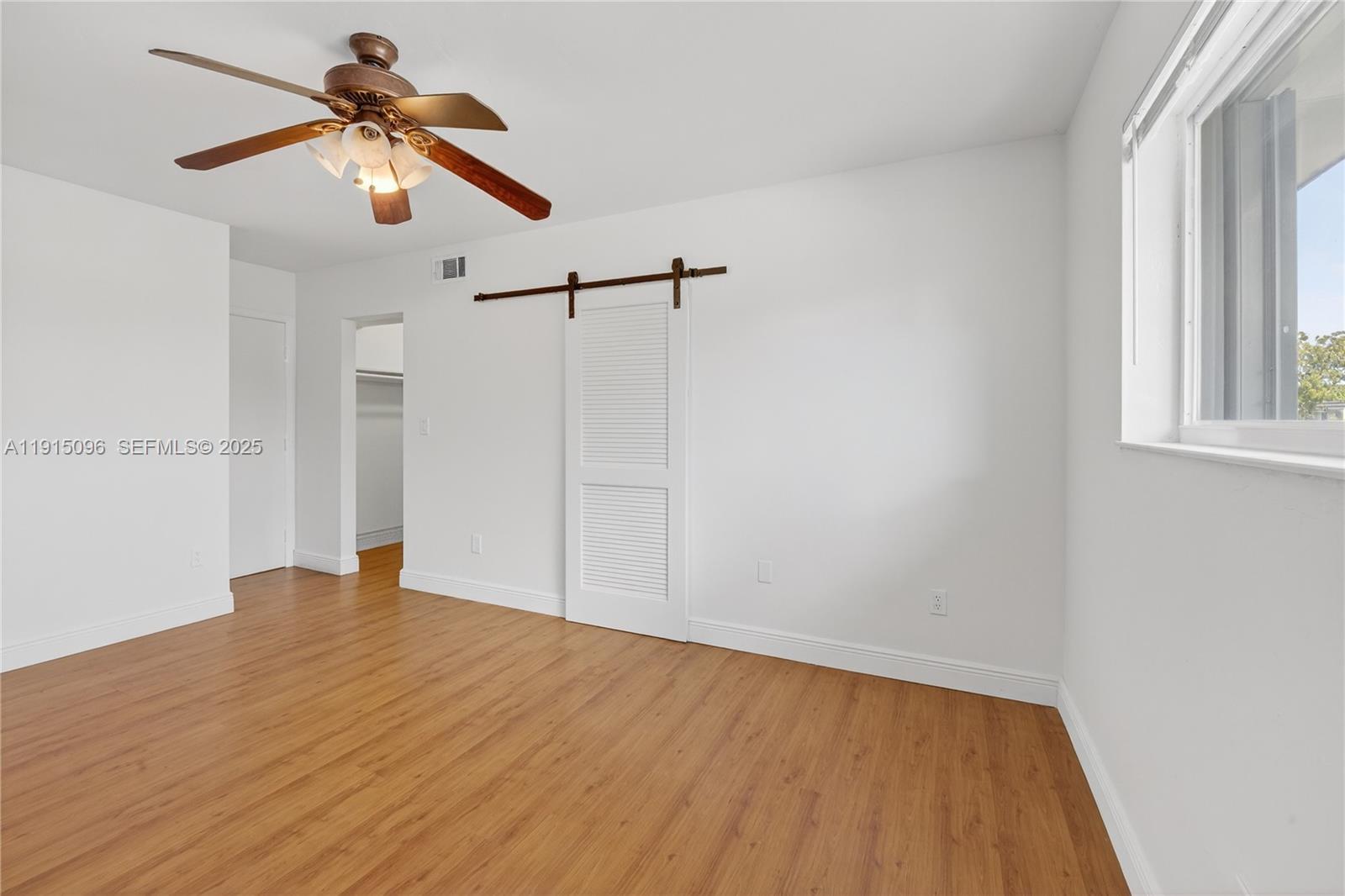 6822 West 2nd Lane Hialeah, FL 33014 - Photo 23 of 36 a view of empty room with wooden floor and fan