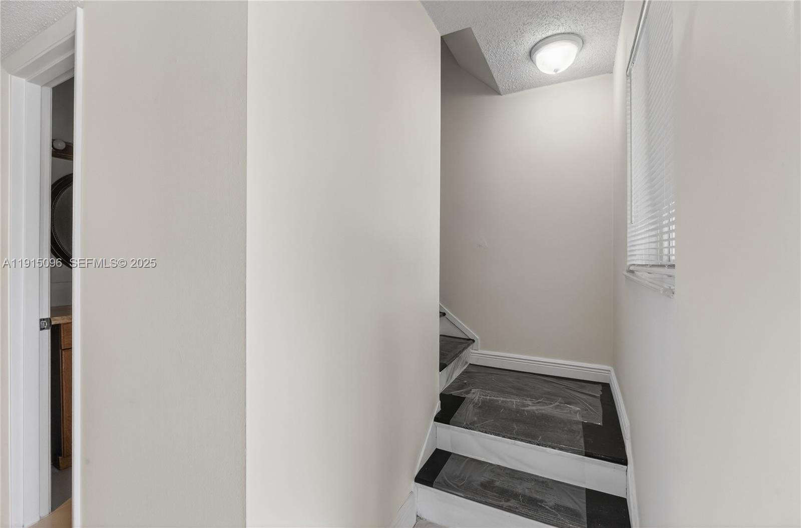 6822 West 2nd Lane Hialeah, FL 33014 - Photo 3 of 36 a view of entryway with wooden floor