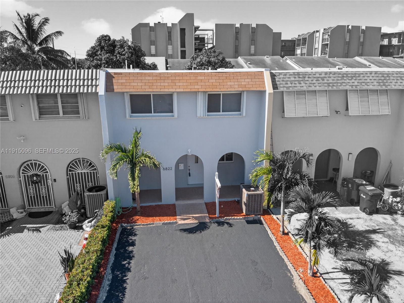 6822 West 2nd Lane Hialeah, FL 33014 - Photo 35 of 36 a front view of a house with balcony and outdoor seating