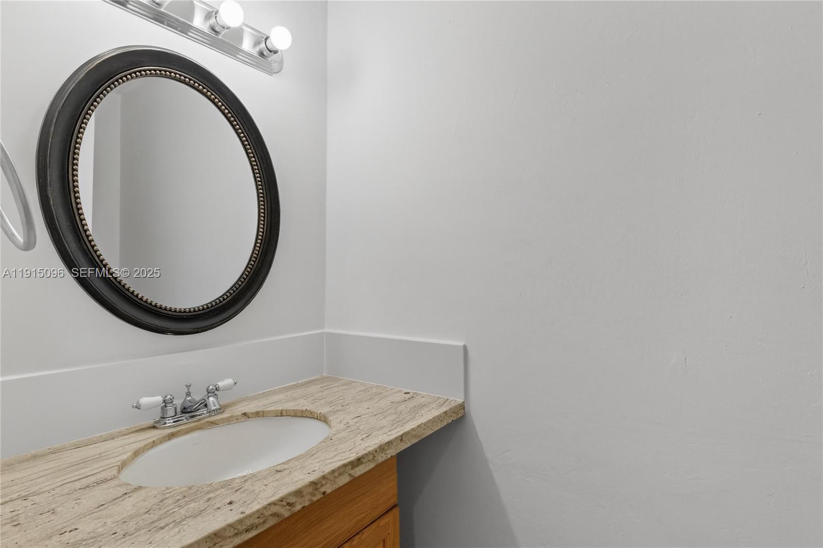 6822 West 2nd Lane Hialeah, FL 33014 - Photo 5 of 36 a bathroom with a granite countertop sink and a mirror