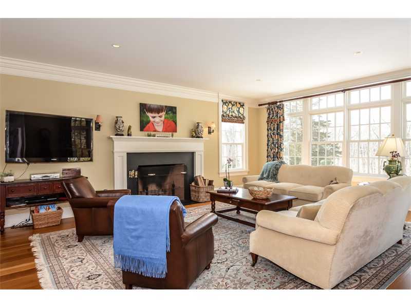 527 Middlesex Road Darien, CT 06820 - Photo 12 of 25 a living room with furniture a flat screen tv and a fireplace