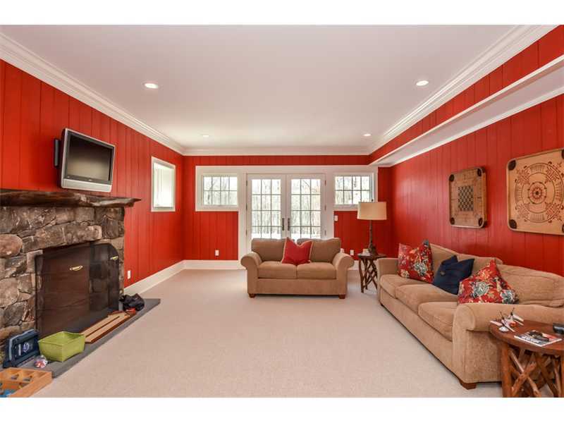 527 Middlesex Road Darien, CT 06820 - Photo 15 of 25 a living room with furniture a flat screen tv and a fireplace