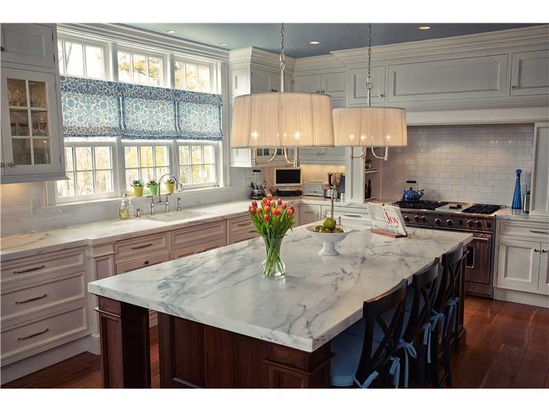 527 Middlesex Road Darien, CT 06820 - Photo 7 of 25 a kitchen with a table chairs and a wooden floor