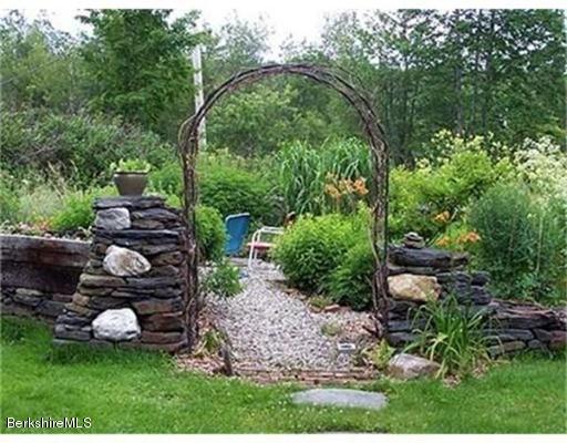 1 Bray Road Heath, MA 01346 - Photo 18 of 23 a view of a backyard with plants and a bench