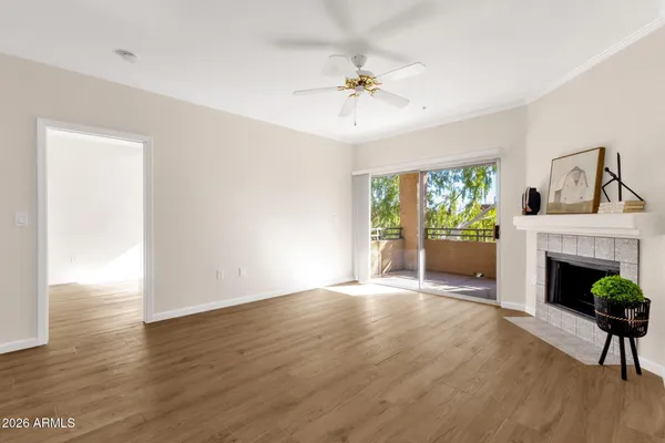 a view of an empty room with a fireplace and a window