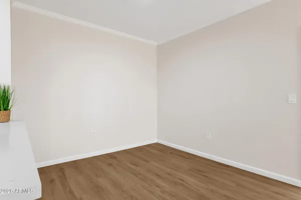 a view of an empty room with wooden floor