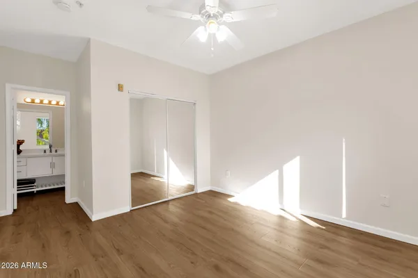 a view of empty room with wooden floor
