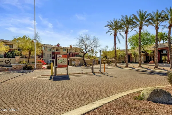 a row of palm trees and swimming pool in the backyard of a house
