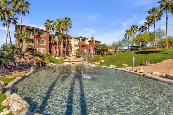 a view of a street with a building and trees in the background