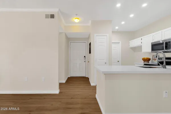 a kitchen with stainless steel appliances a refrigerator and a stove top oven