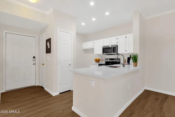 a kitchen with a refrigerator and a stove top oven