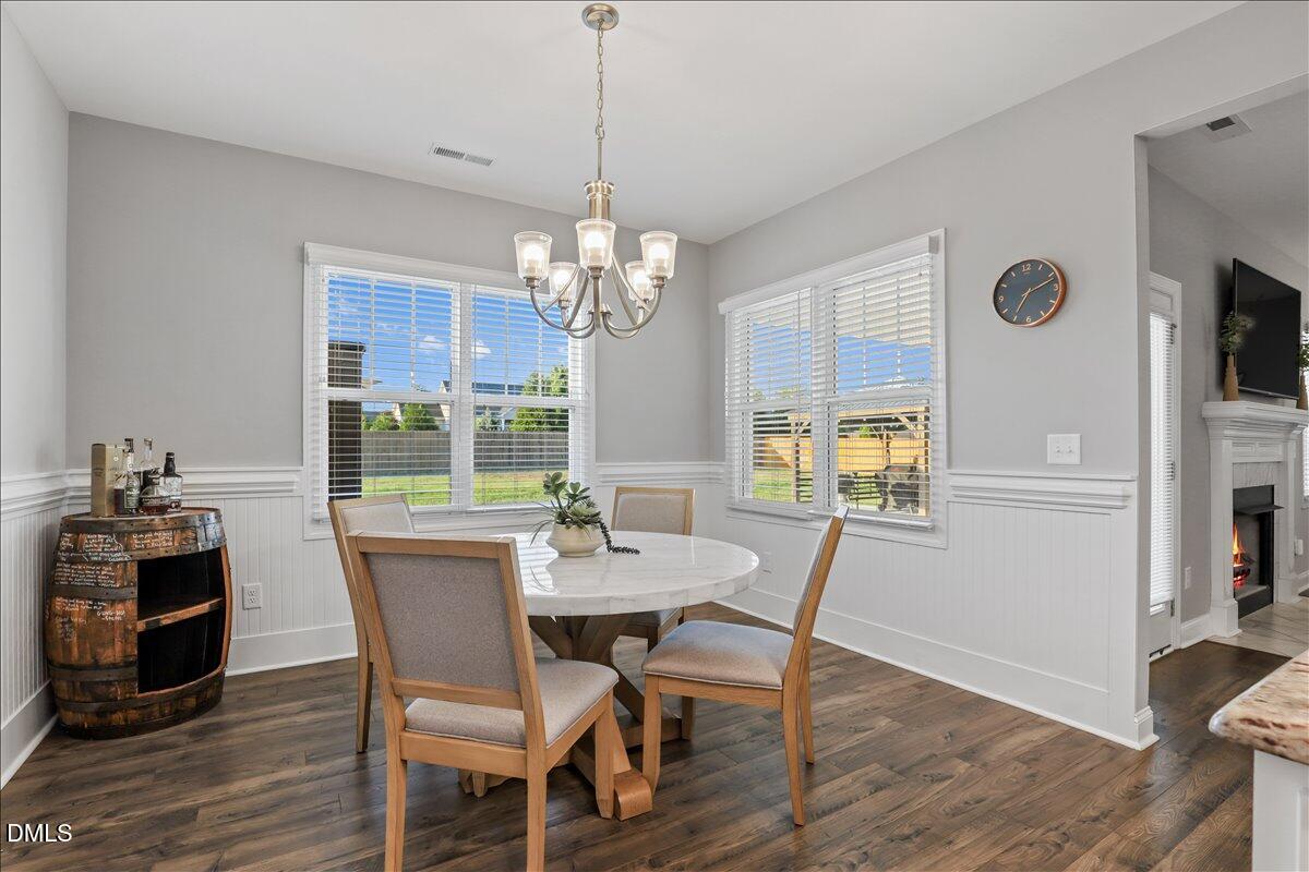 88 Heath Road Lillington, NC 27546 - Photo 40 of 54 a view of a dining room with furniture a chandelier and wooden floor