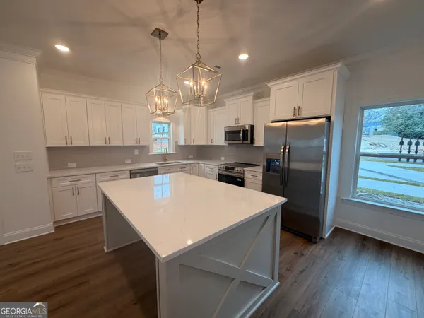 a kitchen with refrigerator cabinets and wooden floor