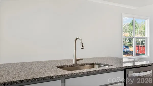 a kitchen with granite countertop a sink and a window