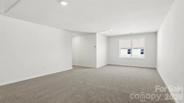 a view of a big room with closet and windows