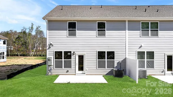 a view of a house with a yard and front view of a house