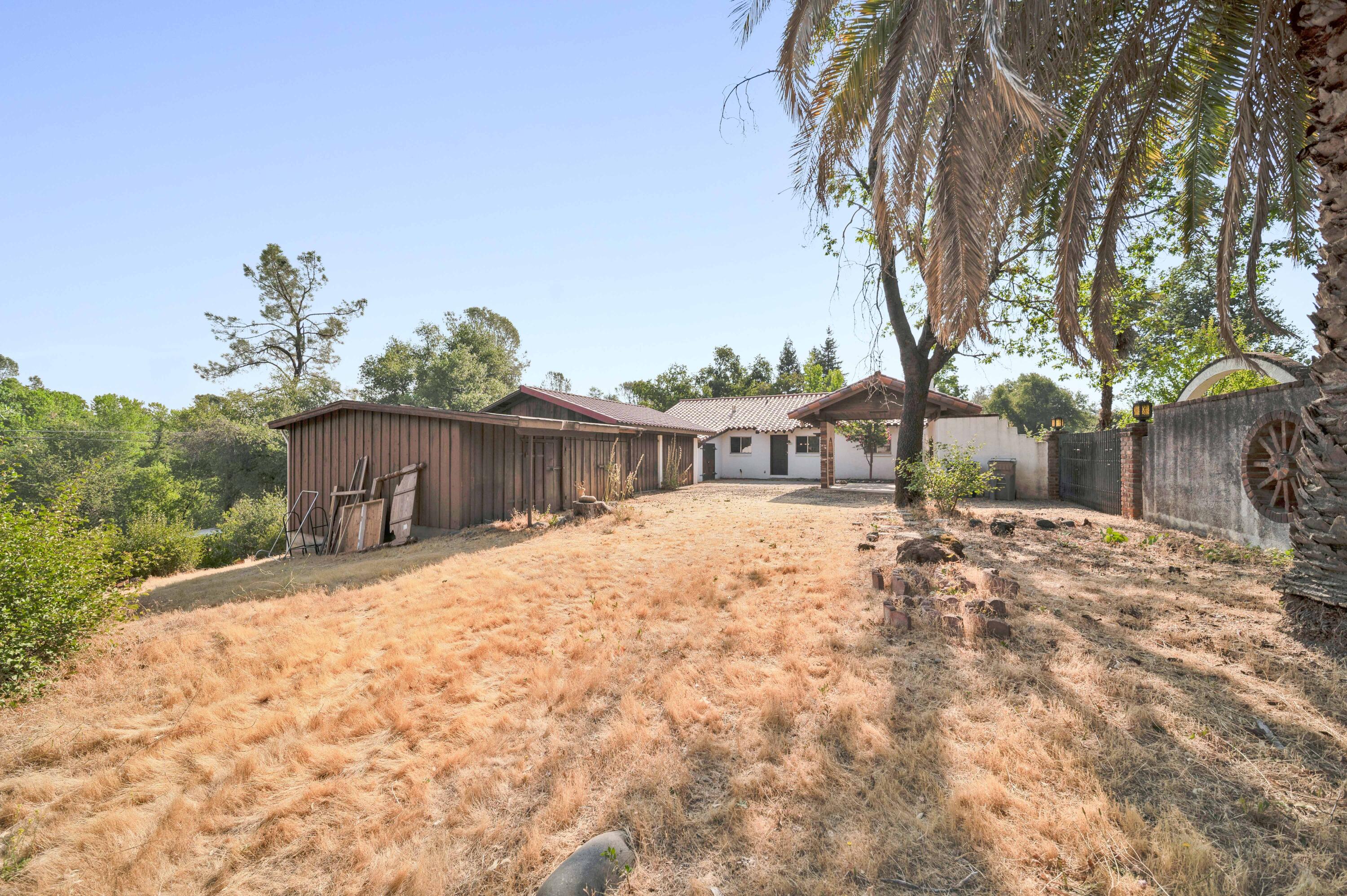 8921 Redbank Road Redding, CA 96001 - Photo 39 of 65 a street view with wooden fence