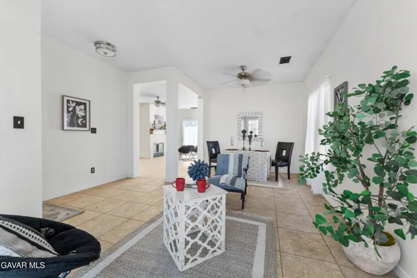 a living room with furniture and a potted plant