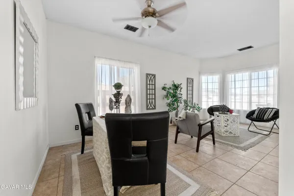 a view of a dining room with furniture and window