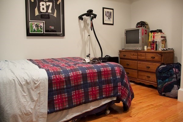 1089 Beacon Street, Unit 1 Brookline, MA 02446 - Photo 6 of 14 a bedroom with a bed and wooden floor