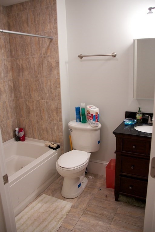 1089 Beacon Street, Unit 1 Brookline, MA 02446 - Photo 8 of 14 a bathroom with a toilet a sink and bathtub
