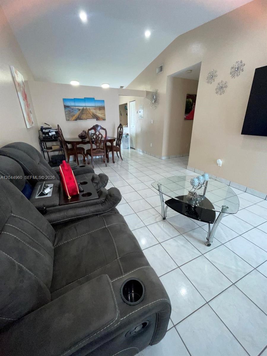 7681 Northwest 178th Terrace Hialeah, FL 33015 - Photo 5 of 11 a living room with furniture and a flat screen tv