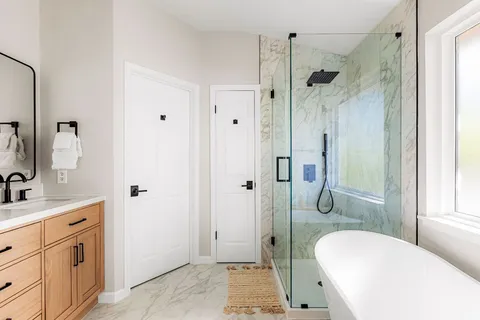 a bathroom with a sink a toilet and shower