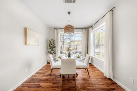 a dining room with furniture window wooden floor