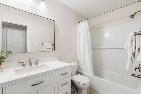a bathroom with a sink toilet and shower