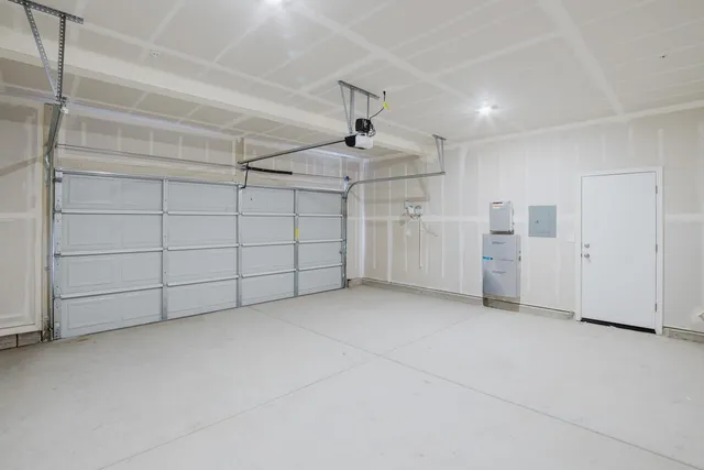a view of kitchen with kitchen island white cabinets and stainless steel appliances