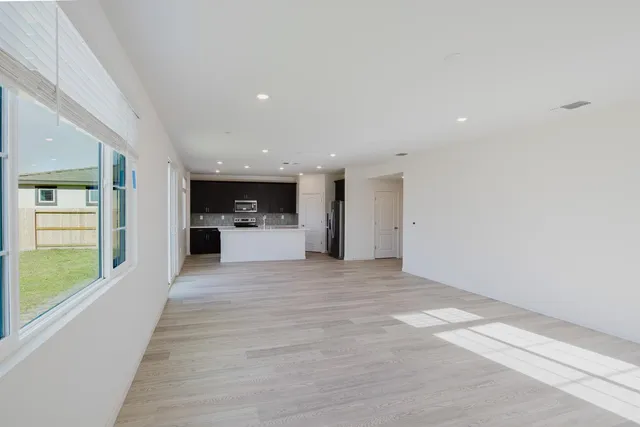 a kitchen with stainless steel appliances granite countertop a sink a stove top oven and refrigerator