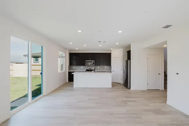 a kitchen with sink cabinets and stainless steel appliances