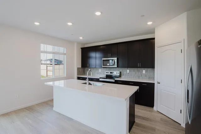 a kitchen with a refrigerator and cabinets