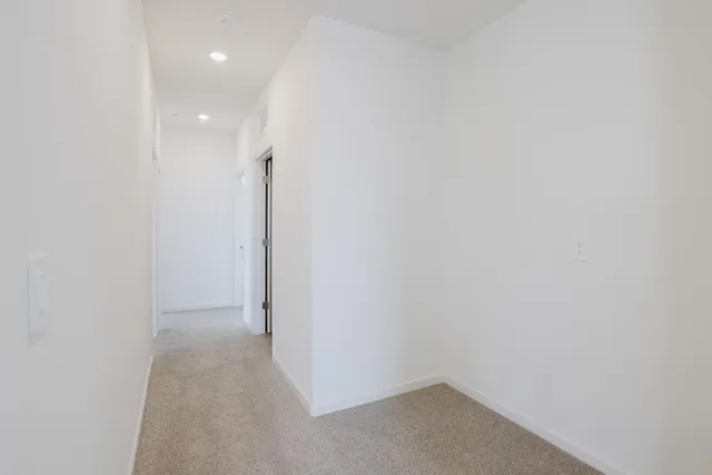 a bathroom with a granite countertop toilet and a shower