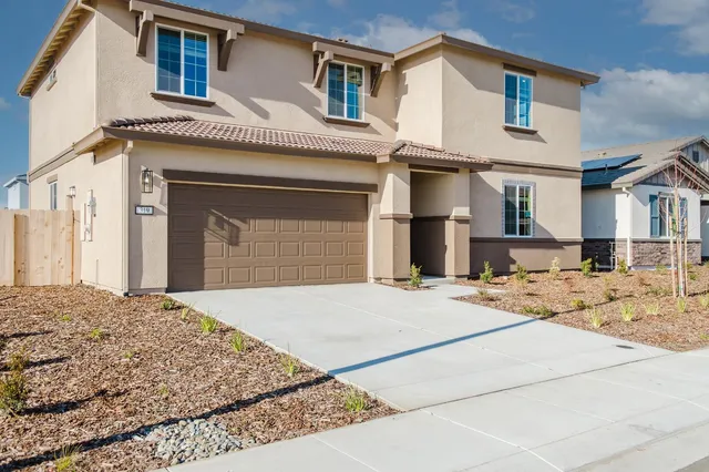 a front view of a house with yard