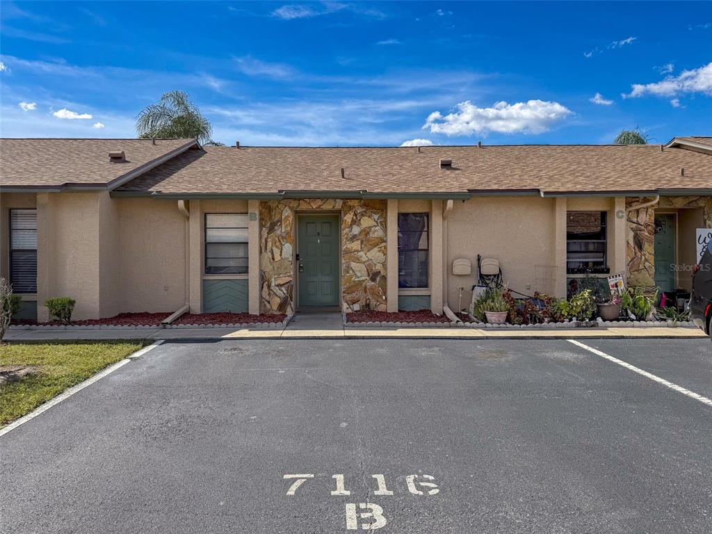 7116 Barclay Avenue, Unit B Spring Hill, FL 34609 - Photo 2 of 31 front view of a house with a patio