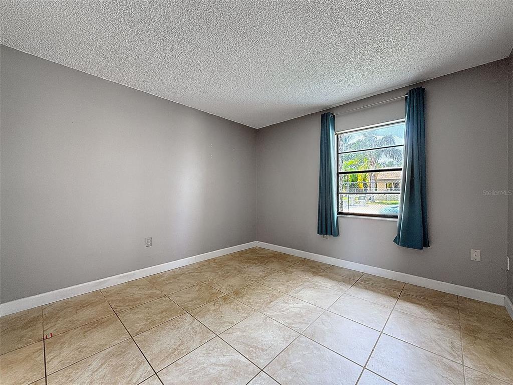 7116 Barclay Avenue, Unit B Spring Hill, FL 34609 - Photo 21 of 31 an empty room with windows
