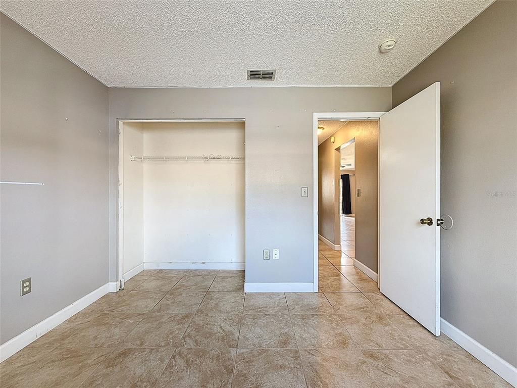 7116 Barclay Avenue, Unit B Spring Hill, FL 34609 - Photo 24 of 31 wooden floor and closet in a room