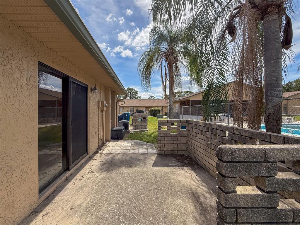 7116 Barclay Avenue, Unit B Spring Hill, FL 34609 - Photo 28 of 31 a view of a patio with couches and a fire pit