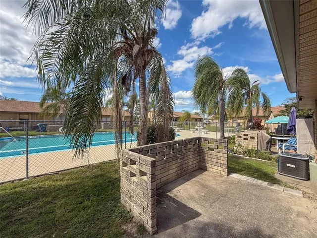 a view of a patio with couches and potted plants
