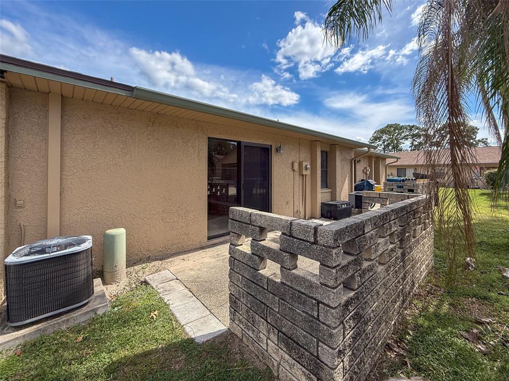 7116 Barclay Avenue, Unit B Spring Hill, FL 34609 - Photo 30 of 31 a view of a patio with couches and potted plants
