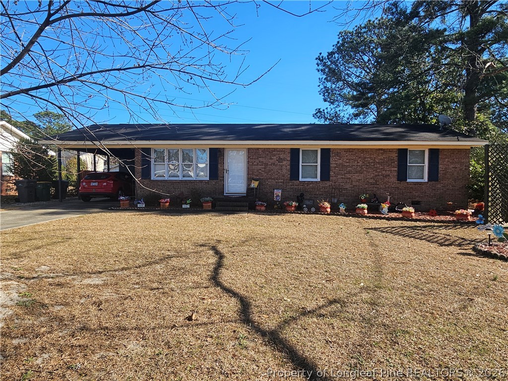 4547 Legion Road Hope Mills, NC 28348 - Photo 1 of 28 a front view of a house with a yard