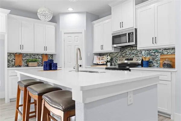 a kitchen with stainless steel appliances a stove microwave and cabinets