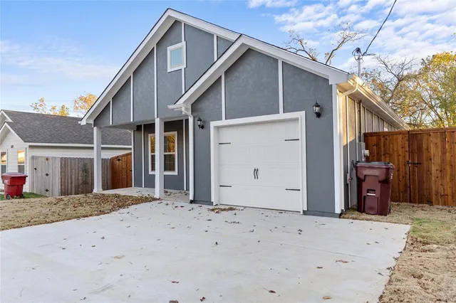 a view of a house with a wooden fence