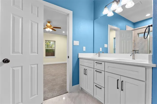a bathroom with a double vanity sink and a mirror